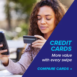 Woman looking at a payment card and phone